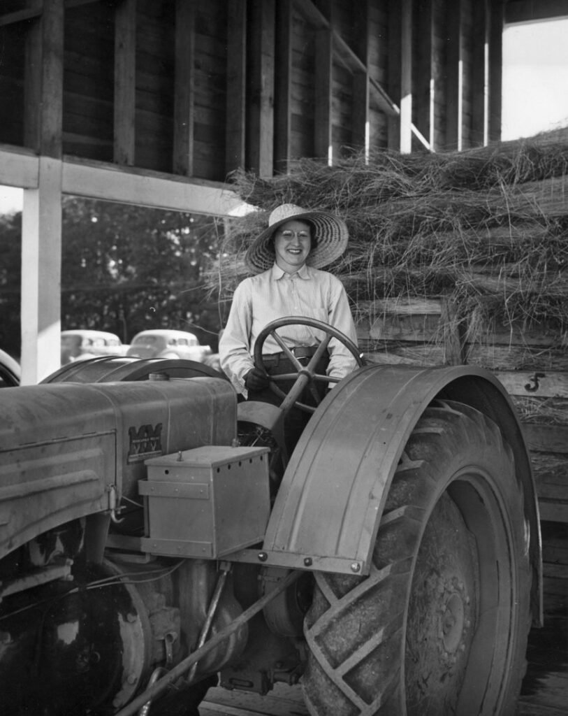 Mrs. Elsie Hill driving a Minneapolis-Moline tractor, 1944